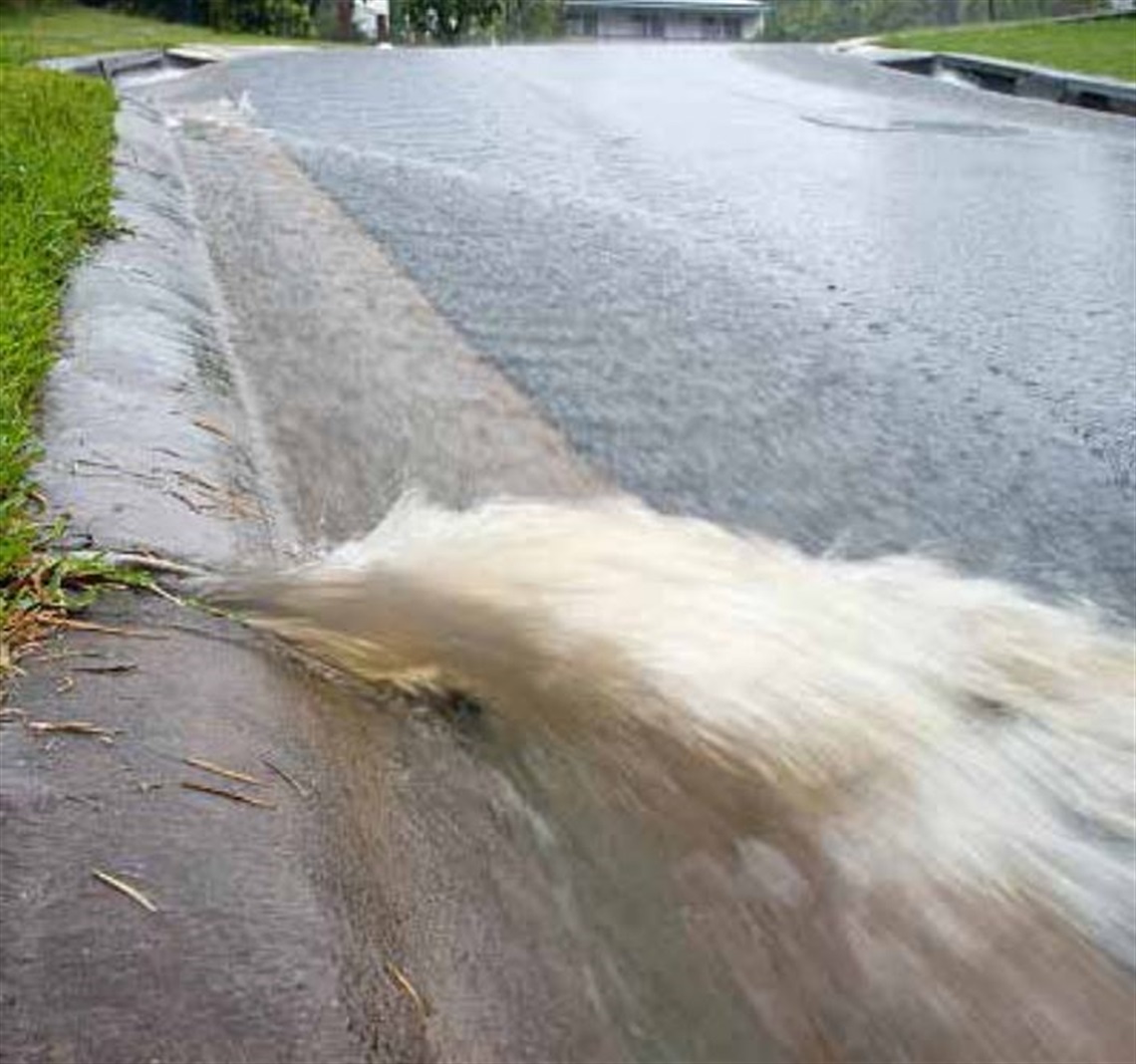 image of stormwater gushing from roadside drain
