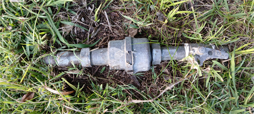 Image of a meter that has been damaged from a mower.